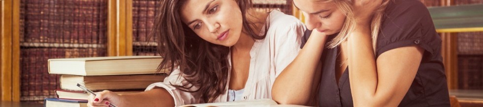Two female students in a library